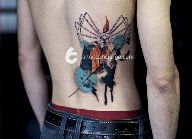 Deer-horns-flames-and-skulls---abstract-lower-back-watercolor-body-art---the-tattoo-concierge---global-platform